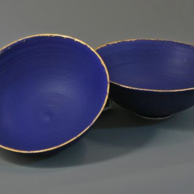 2 small midnight blue bowls with gold leaf rims