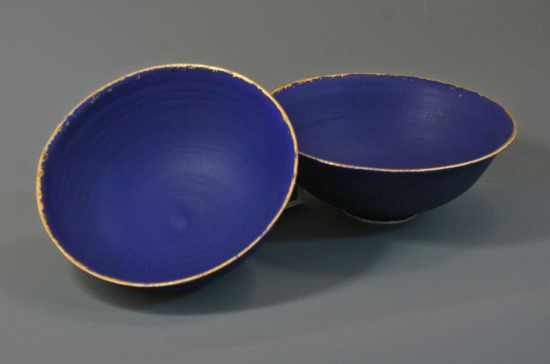 2 small midnight blue bowls with gold leaf rims