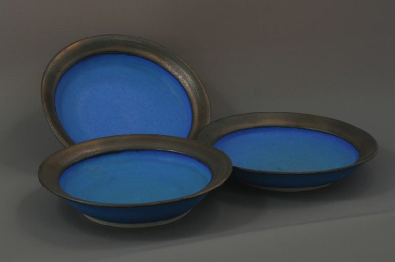 3 small blue dishes with bronzed rims