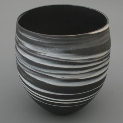 Large white on black agateware beaker