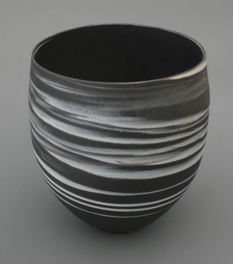 Large white on black agateware beaker