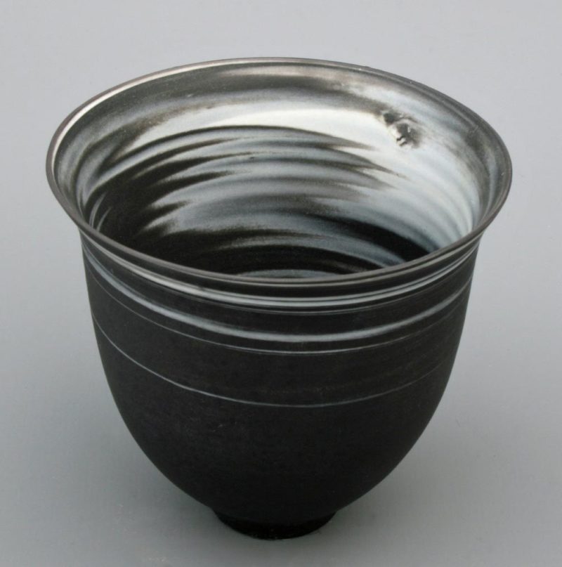 Small white on black agateware beaker